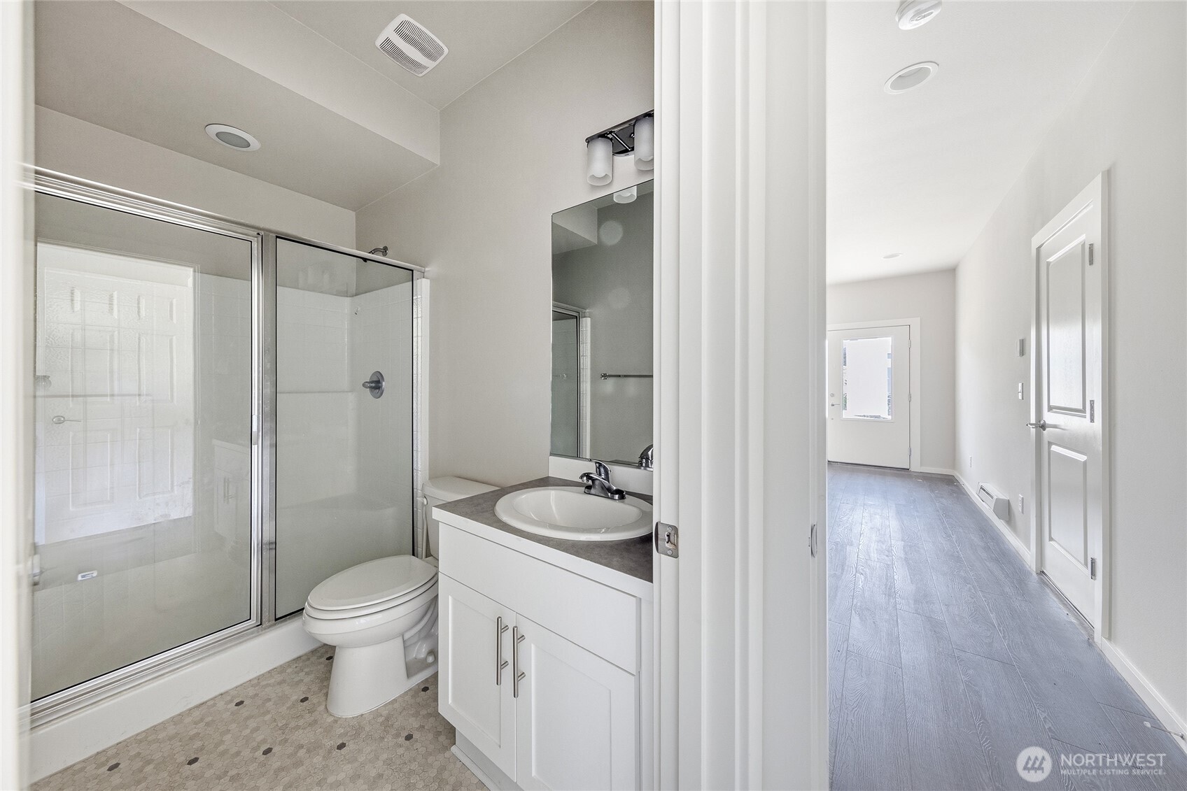 1066 Southwest 99th Place, Unit 55 Seattle, WA 98106 - Photo 20 of 21 a bathroom with a granite countertop sink a toilet and shower