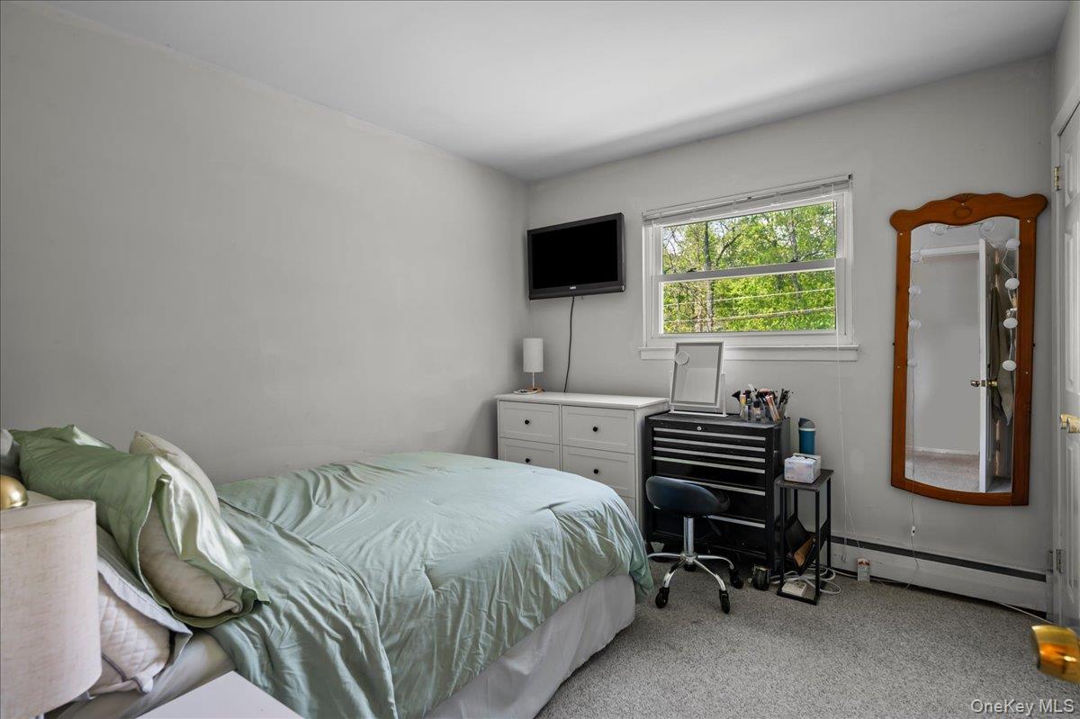 147 Lockwood Road Cortlandt Manor, NY 10567 - Photo 14 of 31 a bedroom with a bed and a television