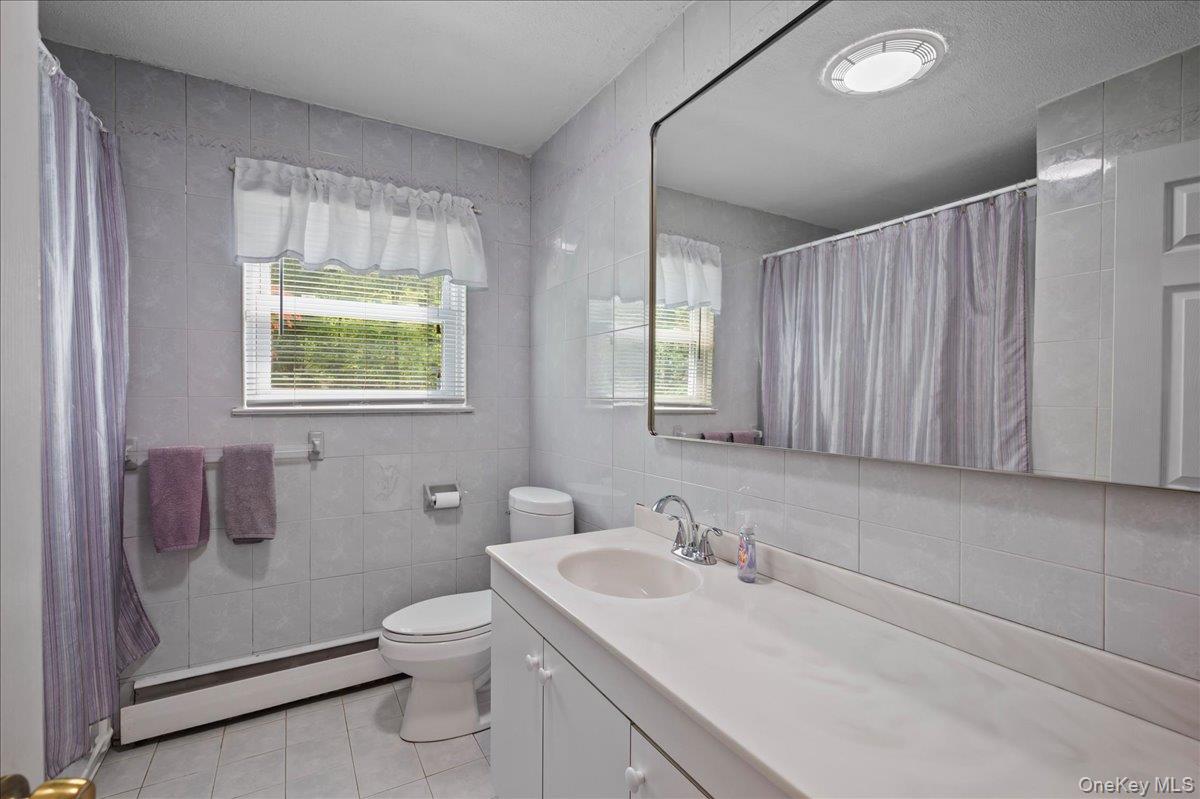 147 Lockwood Road Cortlandt Manor, NY 10567 - Photo 16 of 31 a bathroom with a toilet sink and mirror