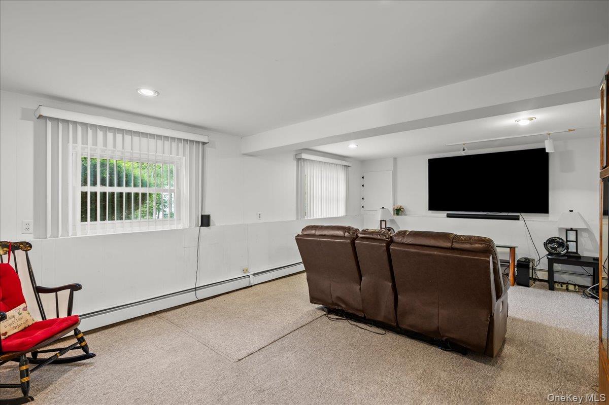147 Lockwood Road Cortlandt Manor, NY 10567 - Photo 19 of 31 a living room with furniture and a flat screen tv