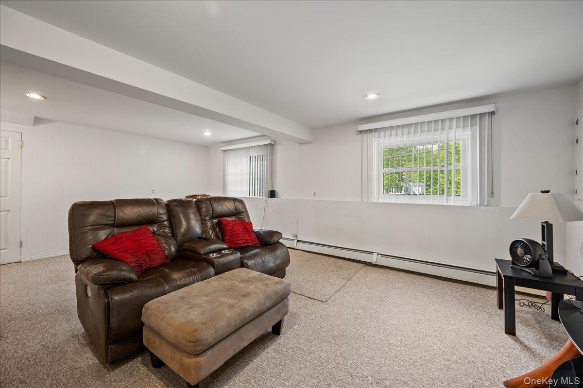 147 Lockwood Road Cortlandt Manor, NY 10567 - Photo 20 of 31 a living room with furniture gym equipment and a window
