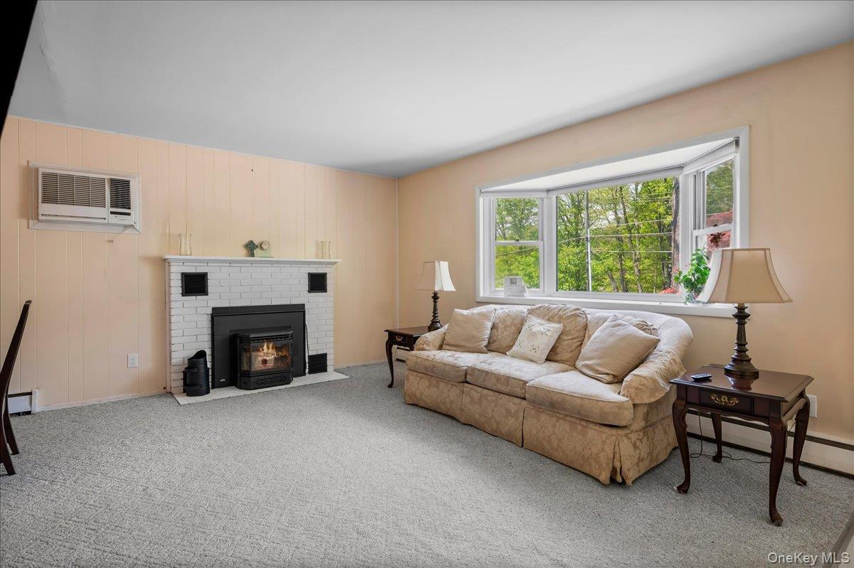 147 Lockwood Road Cortlandt Manor, NY 10567 - Photo 4 of 31 a living room with furniture and a fireplace