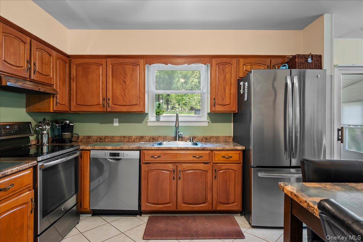 147 Lockwood Road Cortlandt Manor, NY 10567 - Photo 9 of 31 a kitchen with stainless steel appliances granite countertop a stove a sink dishwasher and a refrigerator