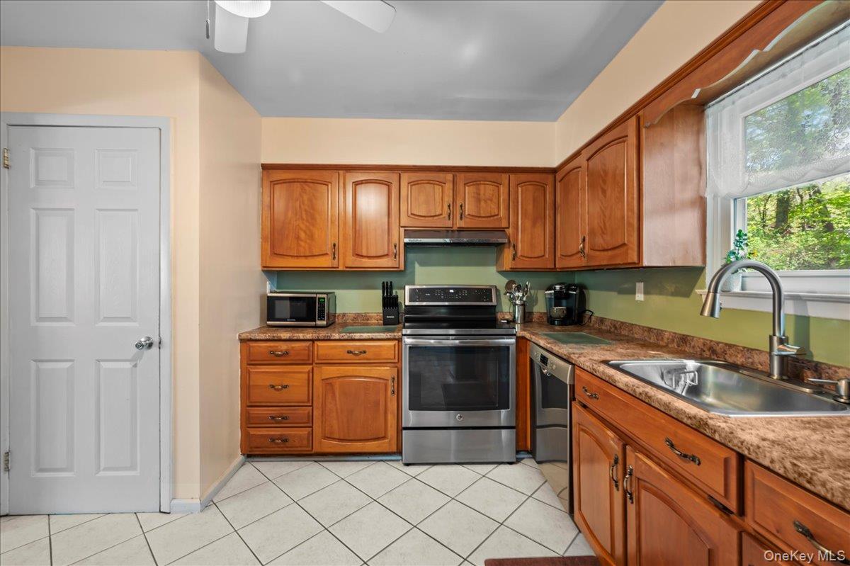 147 Lockwood Road Cortlandt Manor, NY 10567 - Photo 10 of 31 a kitchen with stainless steel appliances granite countertop a stove sink and cabinets