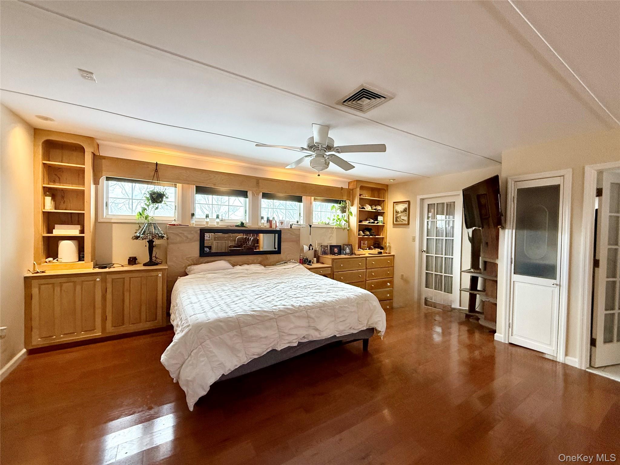 912-918 Hollow Road Salt Point, NY 12578 - Photo 15 of 38 Bedroom with multiple windows, wood finished floors, and a ceiling fan