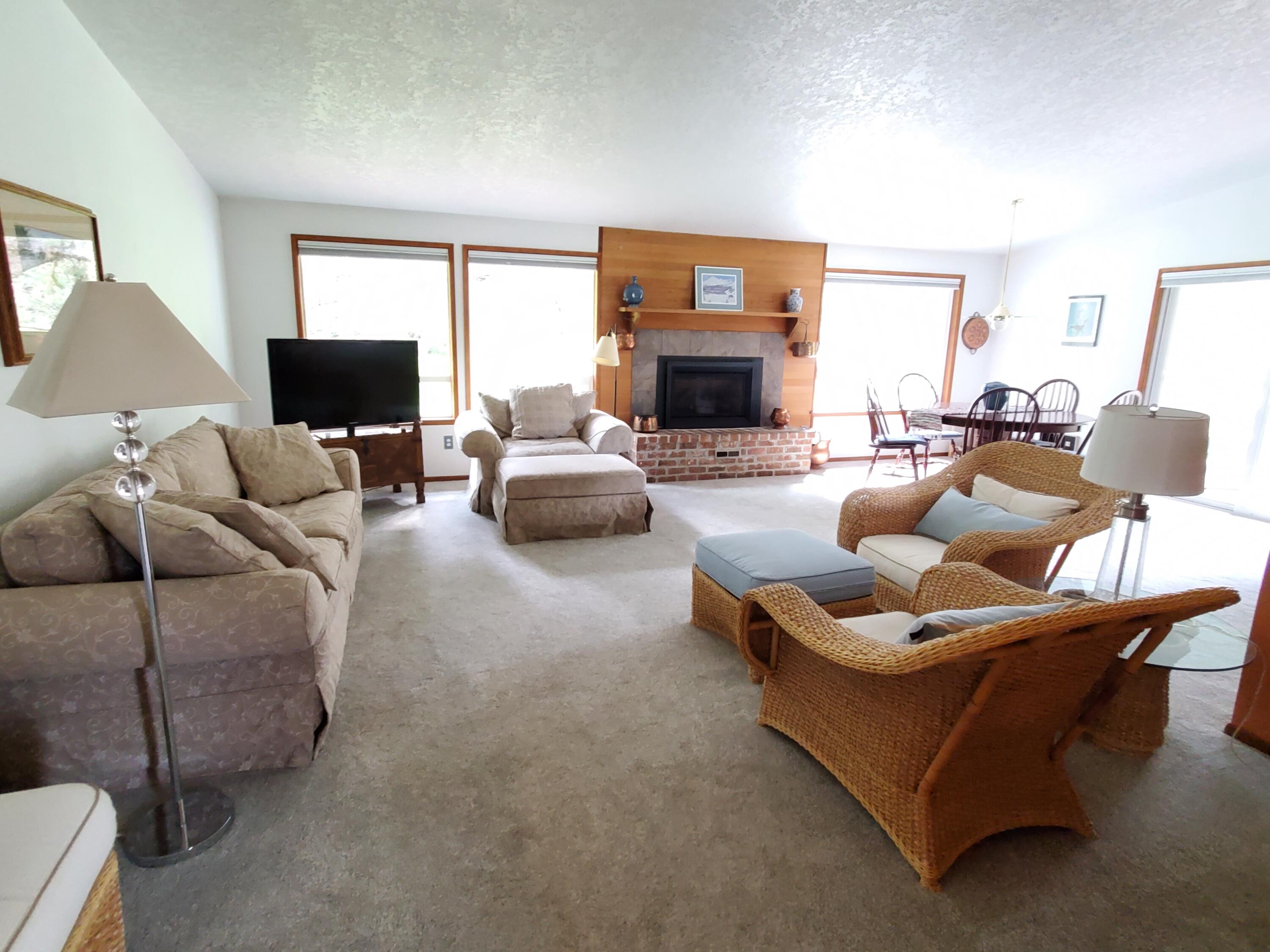 20397 Strawline Road Bend, OR 97702 - Photo 6 of 25 Light and bright with large windows and vaulted ceilings. Cozy gas fireplace too!