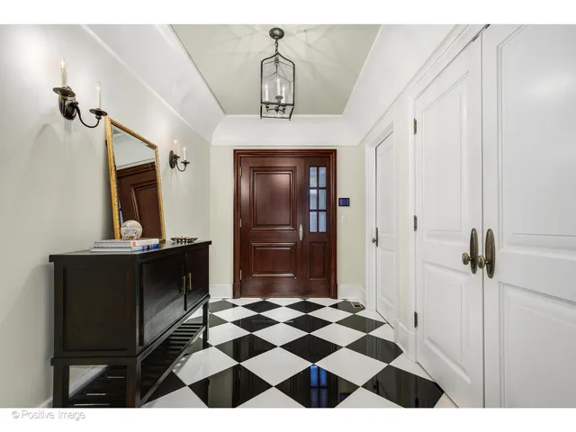 a open dining room with stainless steel appliances kitchen island granite countertop a table chairs and a refrigerator