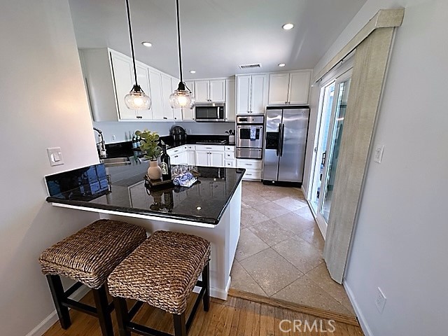 3717 Cherry Long Beach, CA 90807 - Photo 30 of 34 a kitchen with stainless steel appliances granite countertop a sink refrigerator and cabinets
