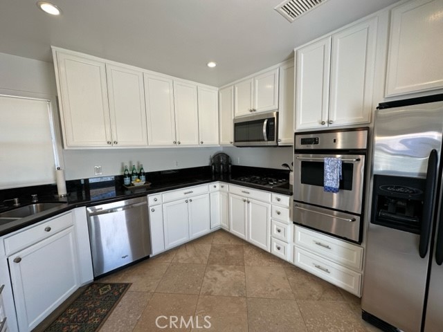3717 Cherry Long Beach, CA 90807 - Photo 33 of 34 a kitchen with granite countertop white cabinets and stainless steel appliances