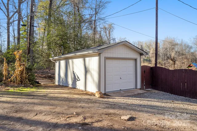 a view of a house with a yard and garage