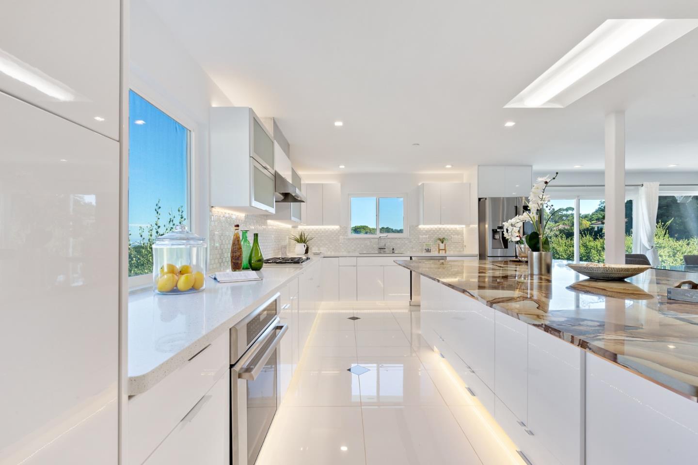22 Bertocchi Lane Millbrae, CA 94030 - Photo 13 of 50 a large white kitchen with lots of counter top space and stainless steel appliances