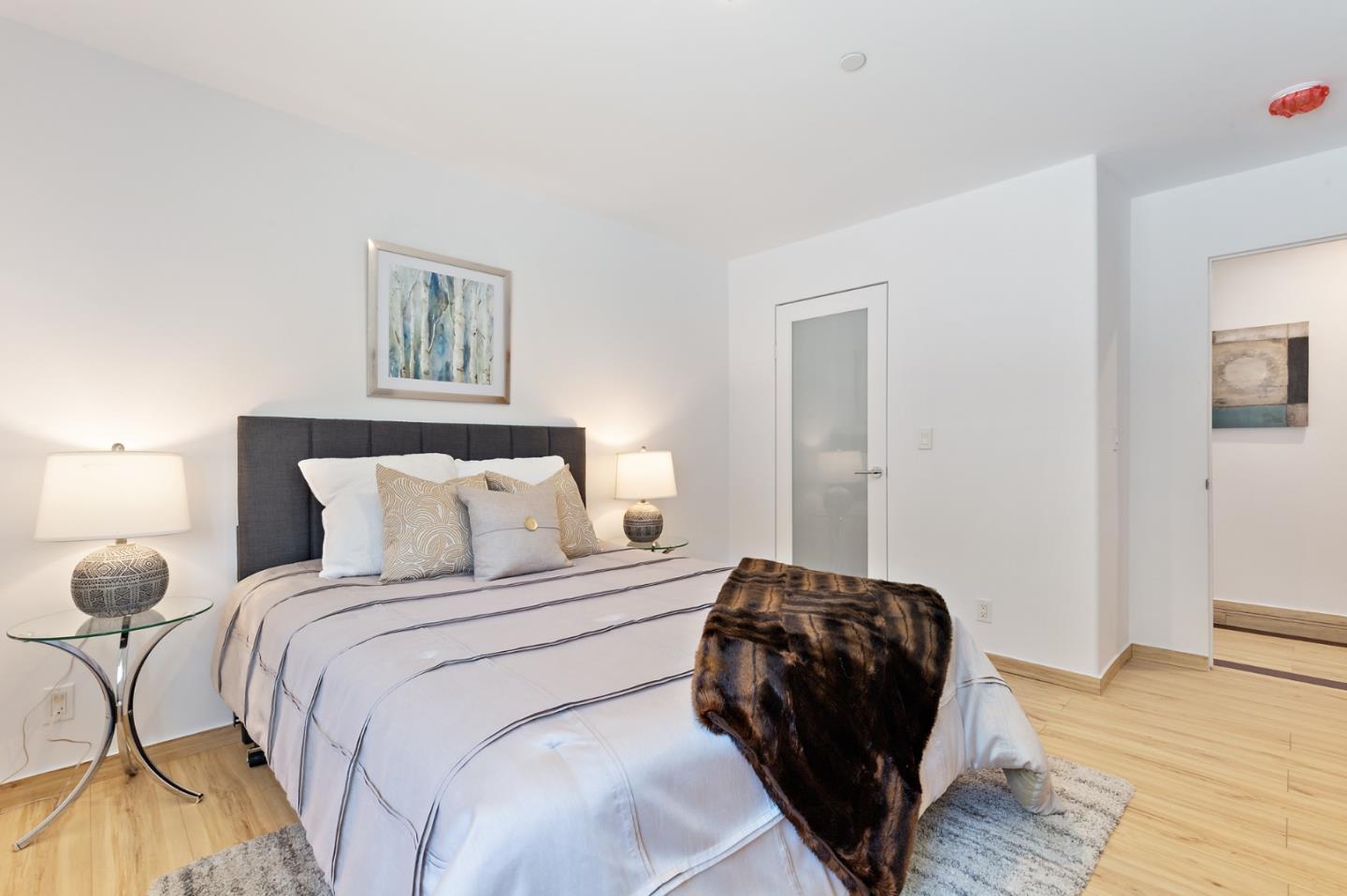 22 Bertocchi Lane Millbrae, CA 94030 - Photo 26 of 50 a bedroom with a bed and a painting on the wall