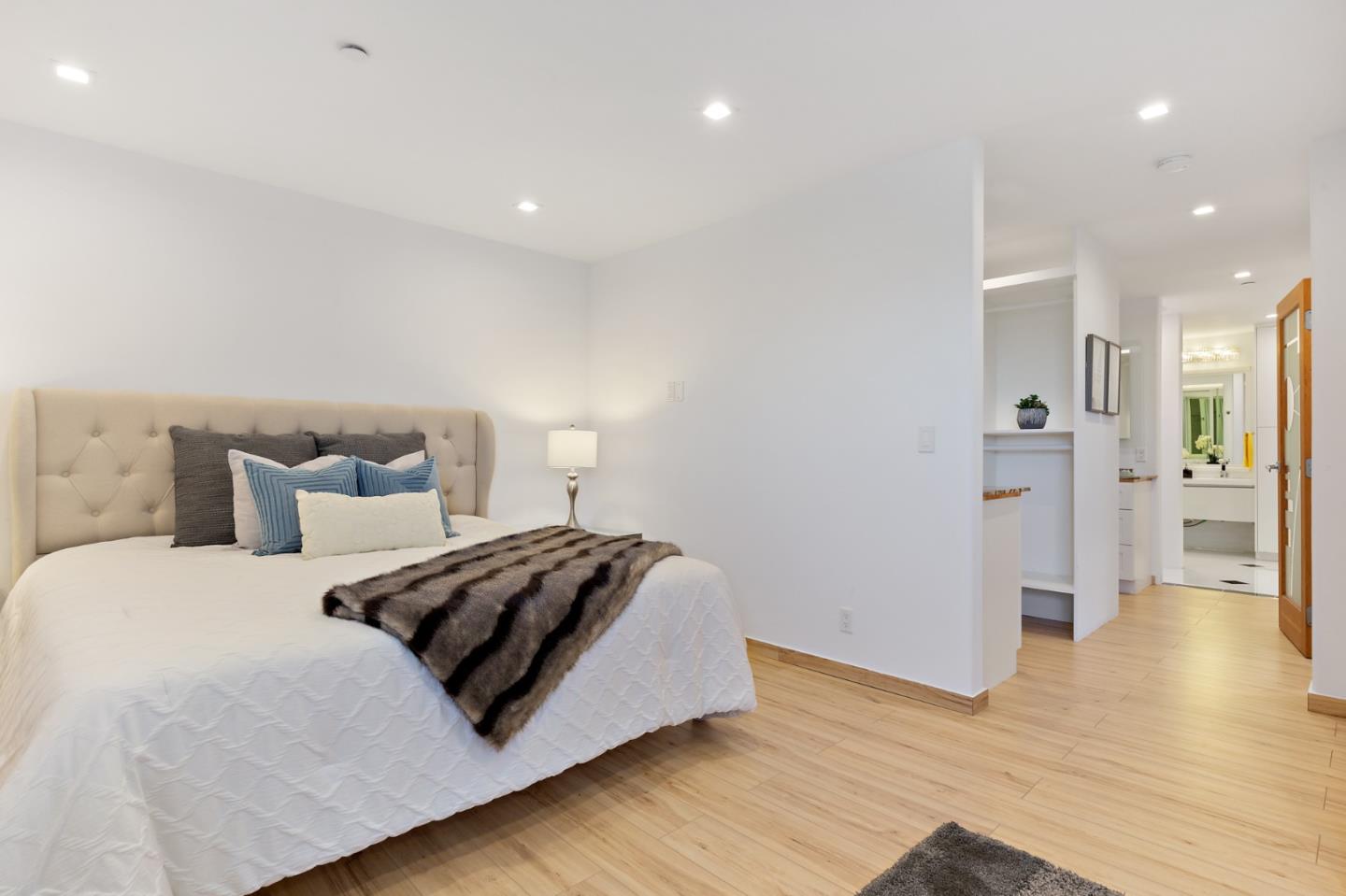22 Bertocchi Lane Millbrae, CA 94030 - Photo 32 of 50 a spacious bedroom with a bed and wooden floor