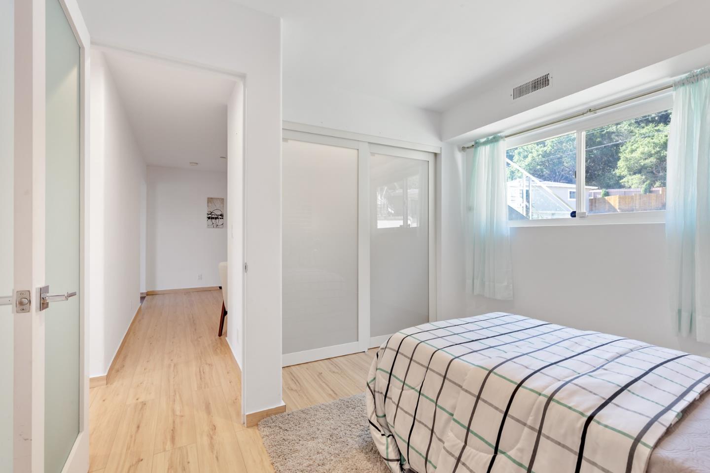 22 Bertocchi Lane Millbrae, CA 94030 - Photo 45 of 50 a bedroom with a bed and a large window