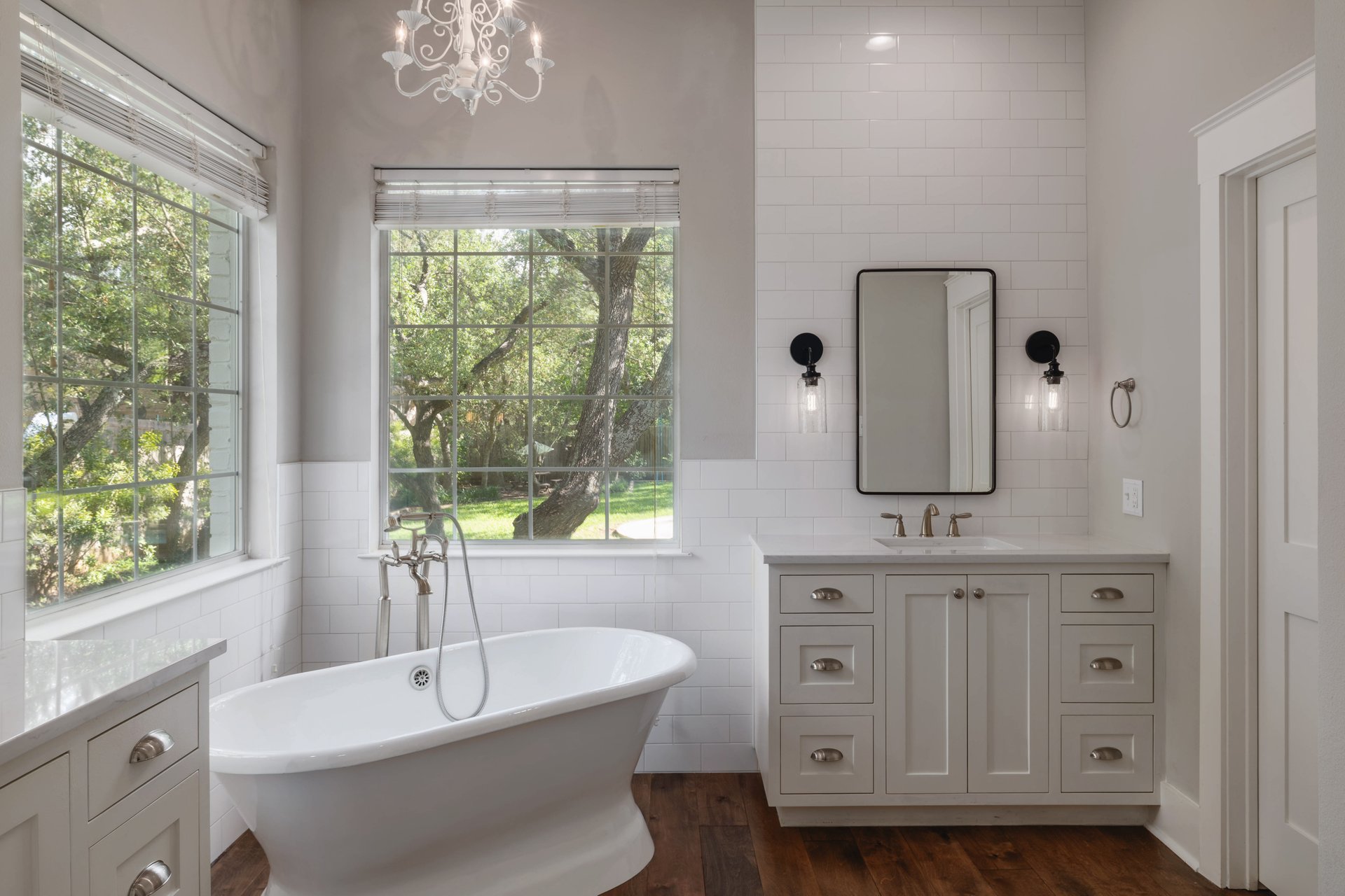 5512 Ballenton Lane Austin, TX 78739 - Photo 21 of 40 A spacious bathroom retreat features a freestanding tub and ample windows overlooking a lush, private yard.