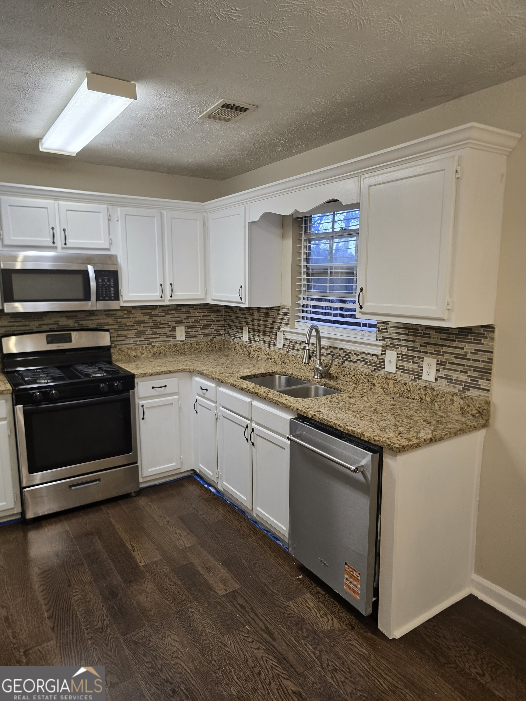 2727 Manor Cove Decatur, GA 30034 - Photo 11 of 16 a kitchen with granite countertop a sink cabinets and stainless steel appliances