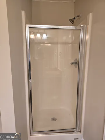 a bathroom with a glass shower door