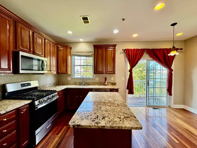 a kitchen with a stove sink and cabinets
