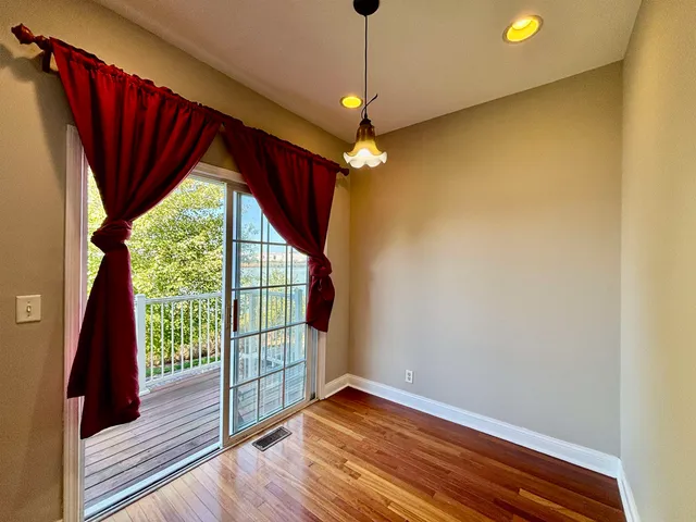 a view of a livingroom with wooden floor and a ceiling fan