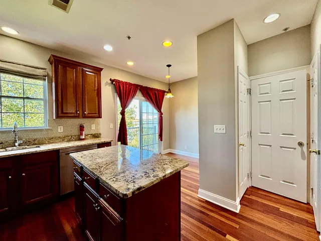 a kitchen with a sink and a wooden floor
