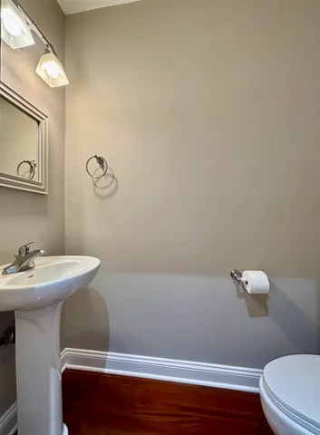 a bathroom with a sink a toilet and a mirror