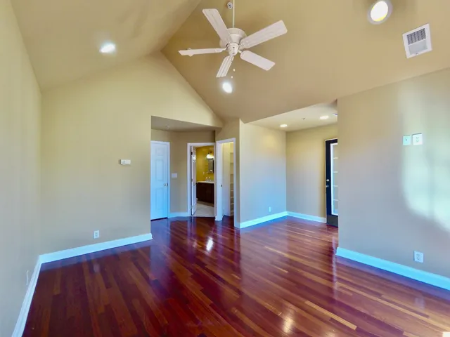 a bathroom with a double vanity sink a toilet a mirror and shower