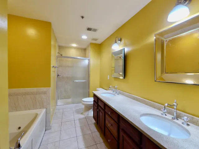 a bathroom with a tub sink and mirror