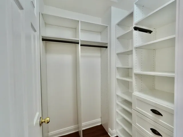 a view of room with window and wooden floor