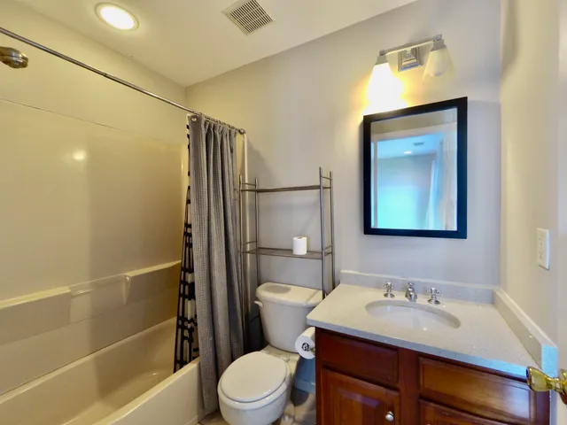 a view of a hallway with wooden floor and windows