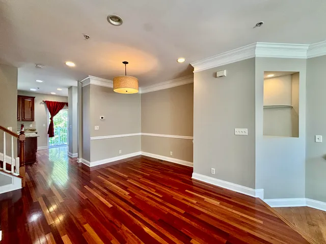 a view of a room with wooden floor
