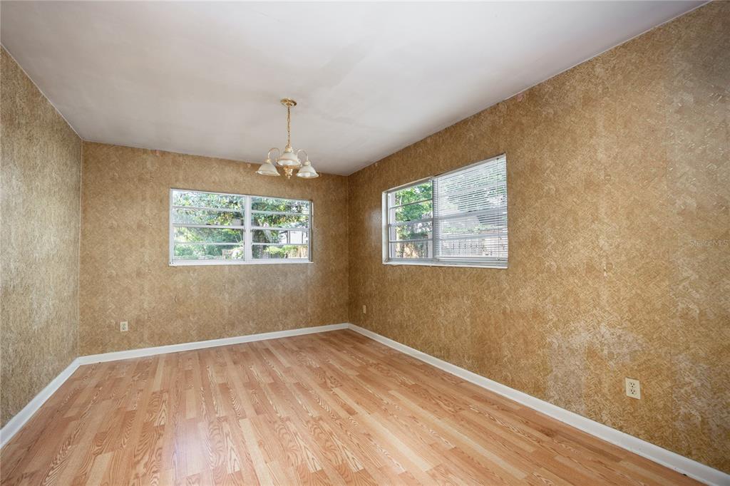 2147 Northwest 7th Place Gainesville, FL 32603 - Photo 12 of 50 a view of an empty room with wooden floor and a window