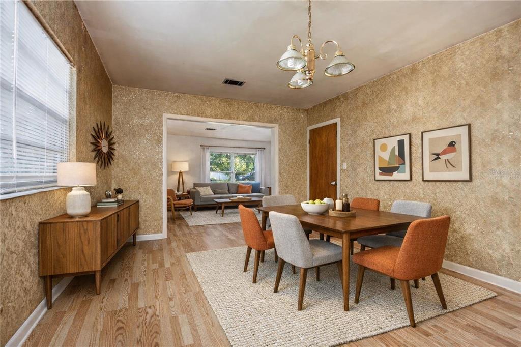 2147 Northwest 7th Place Gainesville, FL 32603 - Photo 13 of 50 a view of a dining room with furniture and wooden floor