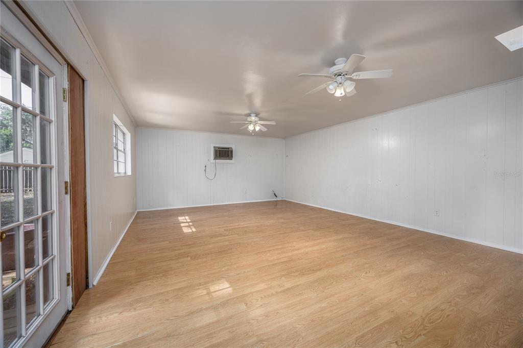 2147 Northwest 7th Place Gainesville, FL 32603 - Photo 20 of 50 a view of an empty room with a chandelier fan and a window