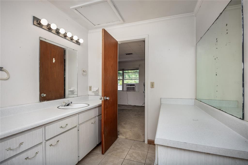 2147 Northwest 7th Place Gainesville, FL 32603 - Photo 34 of 50 a spacious bathroom with a bathtub sink and mirror