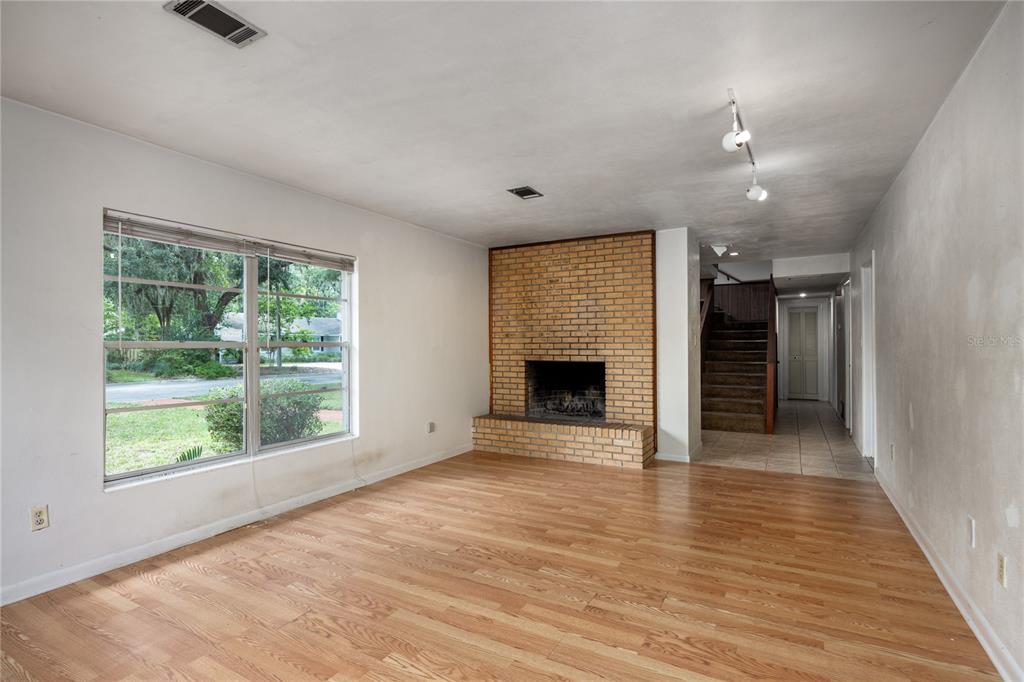 2147 Northwest 7th Place Gainesville, FL 32603 - Photo 10 of 50 wooden floor in an empty room with a fireplace
