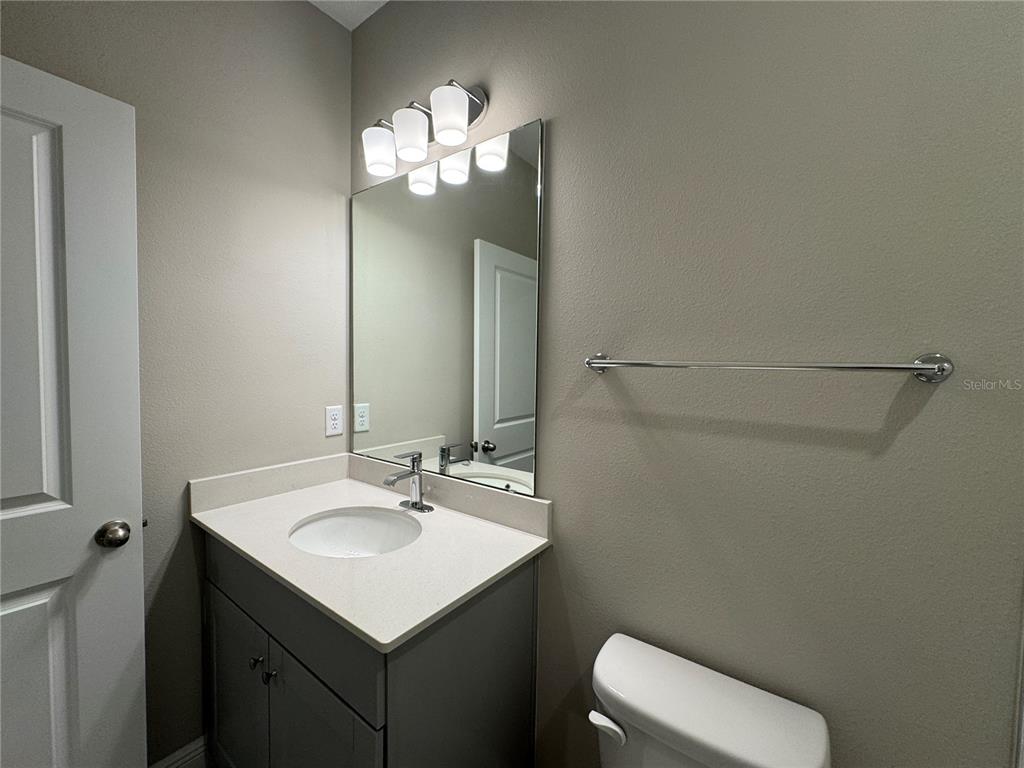 16434 Hamlin Hills Road Winter Garden, FL 34787 - Photo 37 of 50 a bathroom with a sink vanity and toilet