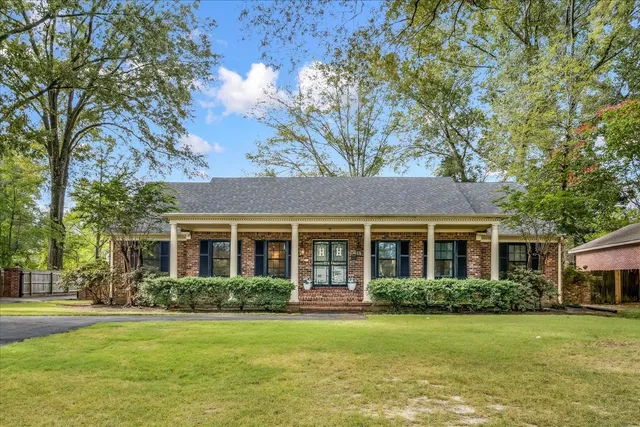 a front view of a house with a garden