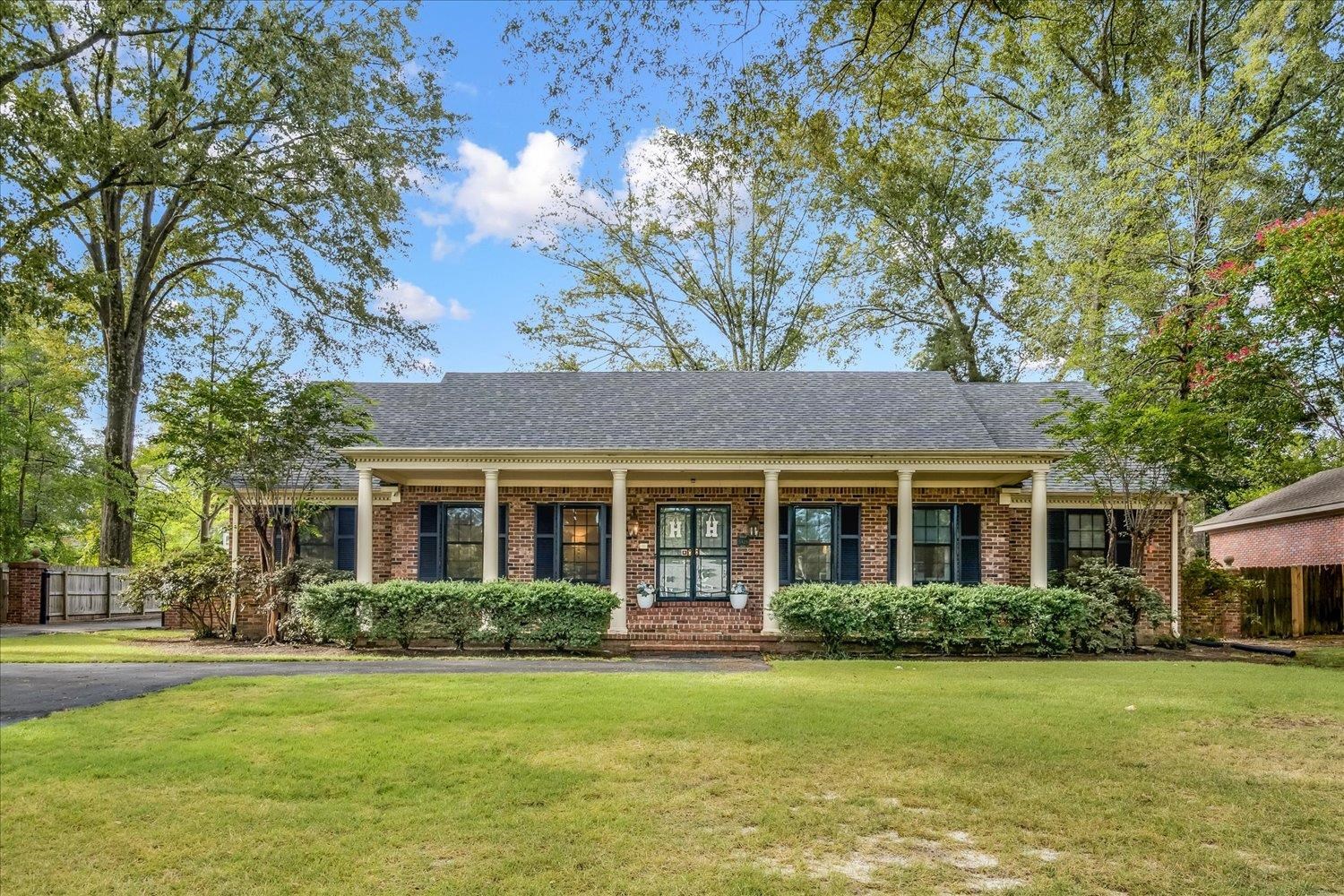 a front view of a house with a garden