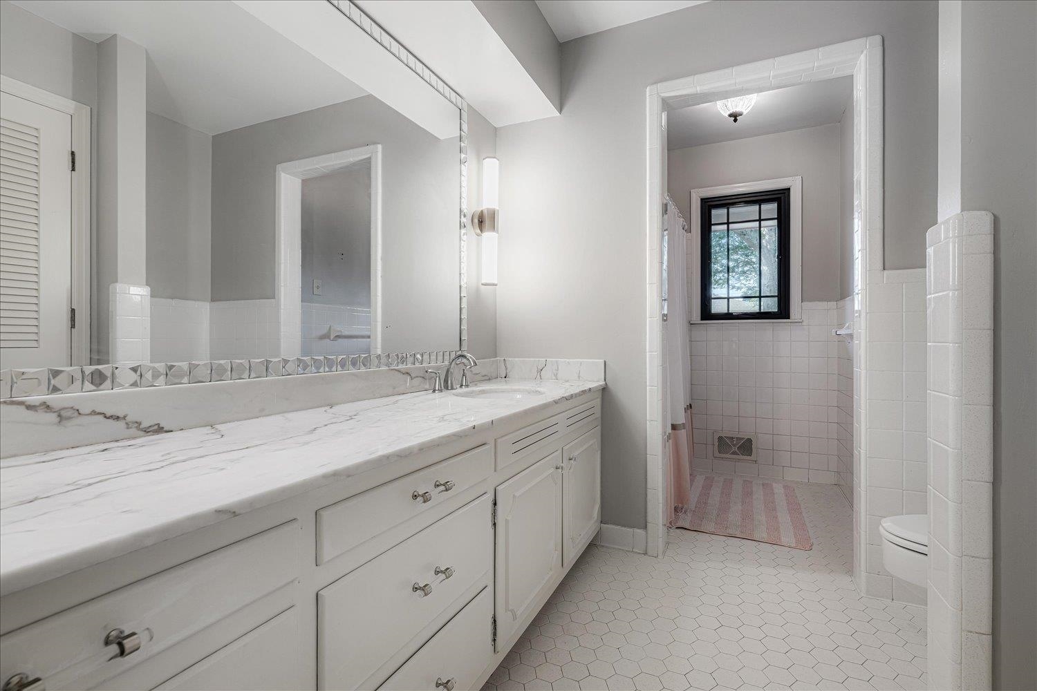 5429 Walnut Grove Road Memphis, TN 38120 - Photo 12 of 37 a bathroom with a sink and a mirror
