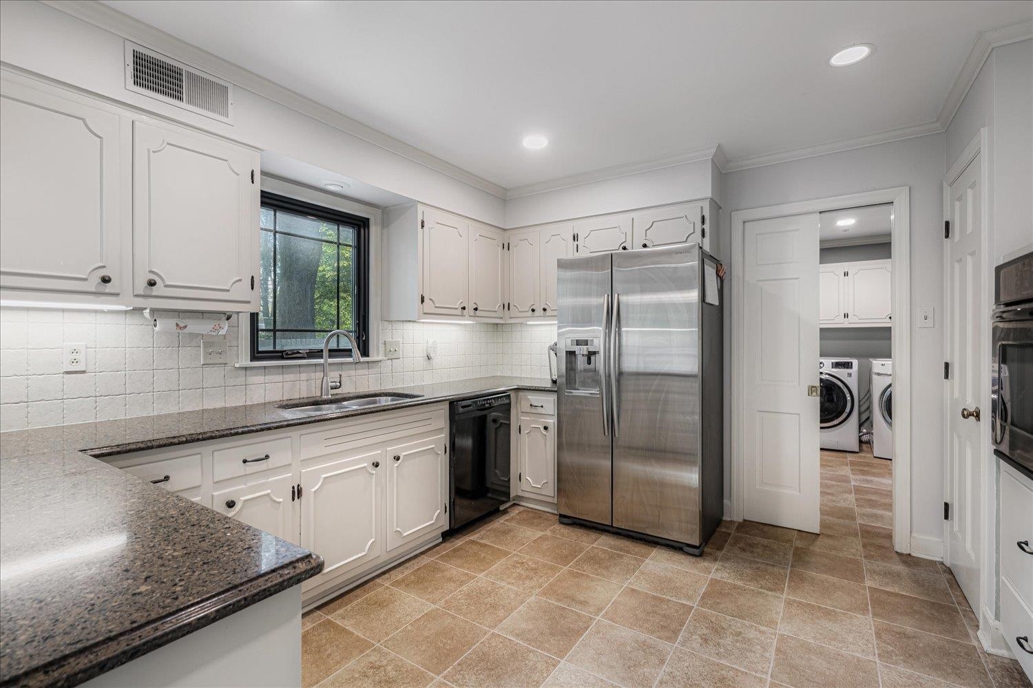 5429 Walnut Grove Road Memphis, TN 38120 - Photo 14 of 37 a kitchen with stainless steel appliances granite countertop a refrigerator and a sink