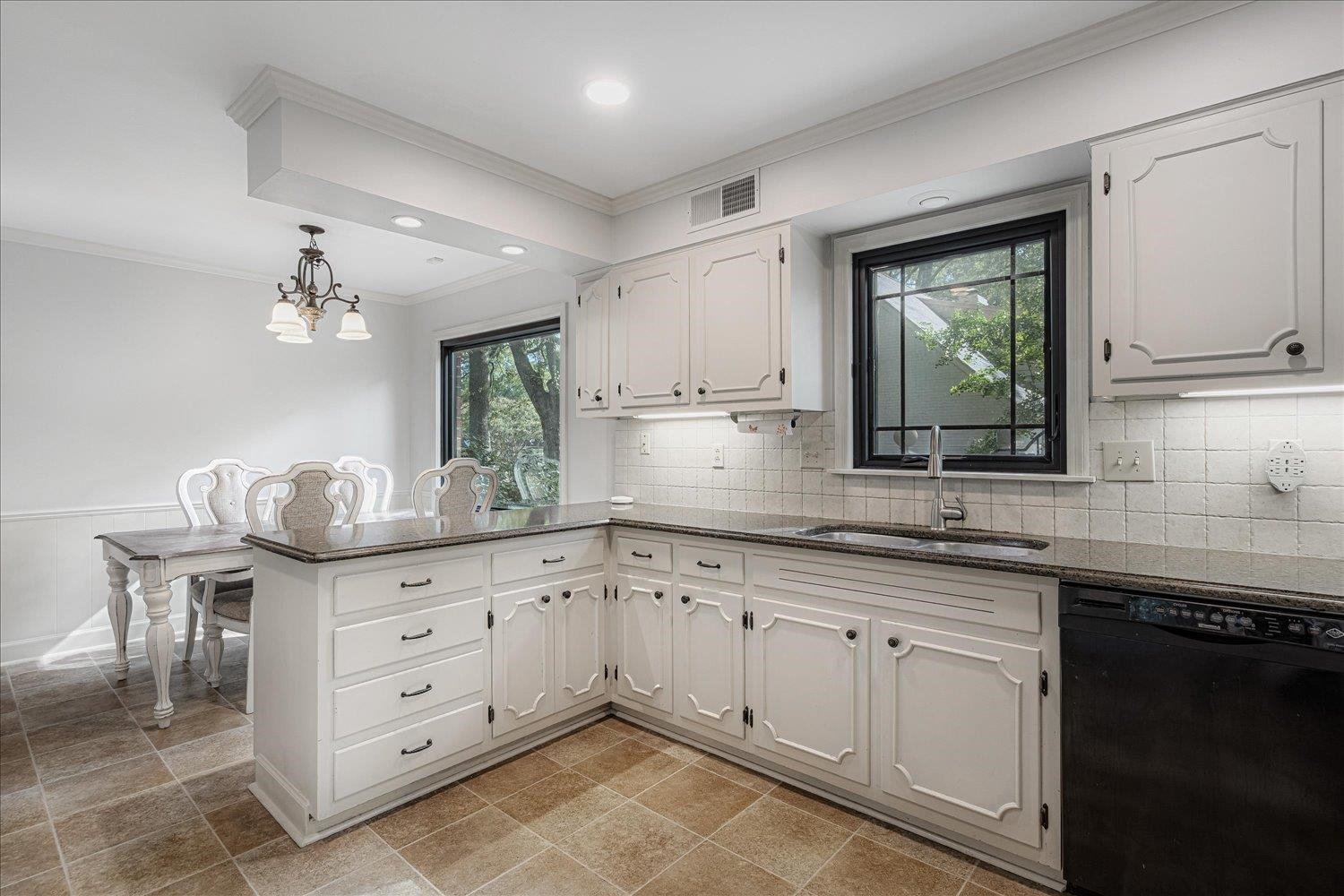 5429 Walnut Grove Road Memphis, TN 38120 - Photo 15 of 37 a kitchen with granite countertop a sink cabinets and wooden floor