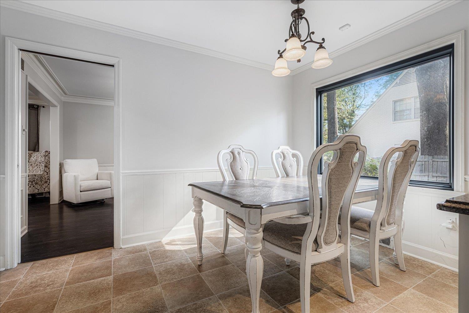 5429 Walnut Grove Road Memphis, TN 38120 - Photo 16 of 37 a view of a dining room with furniture and chandelier