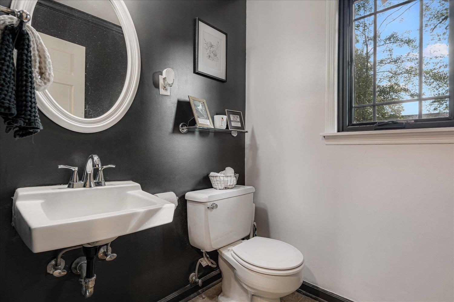 5429 Walnut Grove Road Memphis, TN 38120 - Photo 18 of 37 a bathroom with a sink a mirror and a toilet