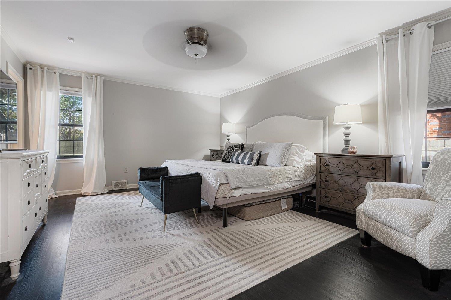 5429 Walnut Grove Road Memphis, TN 38120 - Photo 19 of 37 a spacious bedroom with a bed and wooden floor