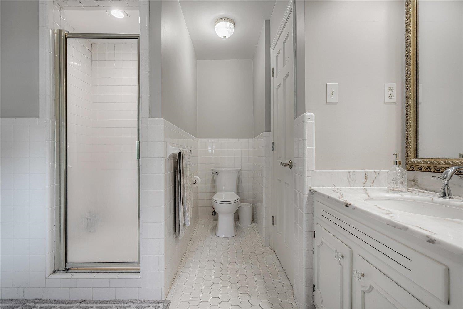 5429 Walnut Grove Road Memphis, TN 38120 - Photo 22 of 37 a bathroom with a sink and mirror with toilet