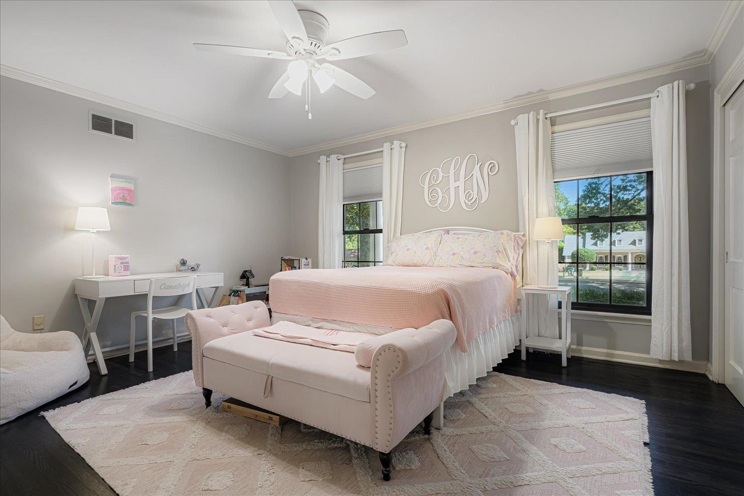 5429 Walnut Grove Road Memphis, TN 38120 - Photo 25 of 37 a bedroom with a bed and a chandelier