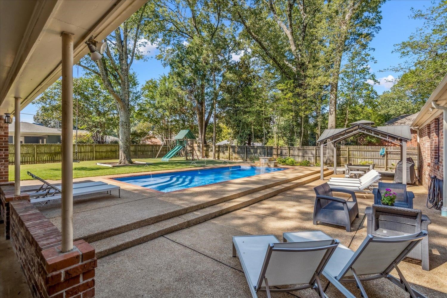 5429 Walnut Grove Road Memphis, TN 38120 - Photo 30 of 37 a view of backyard with swimming pool and seating space