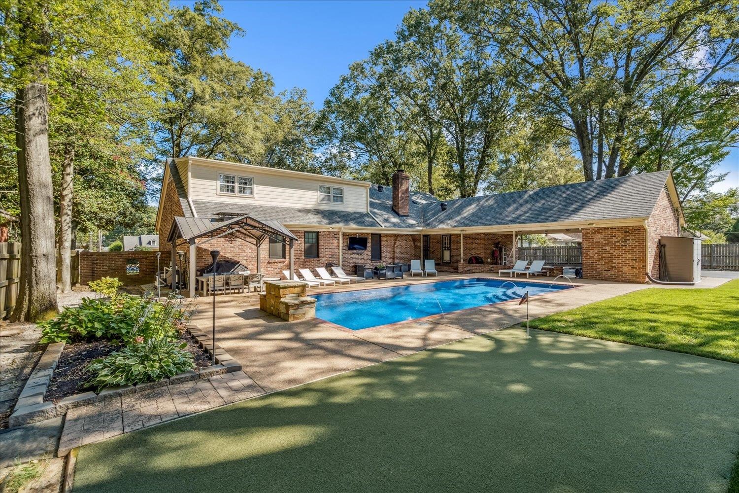 5429 Walnut Grove Road Memphis, TN 38120 - Photo 33 of 37 a view of swimming pool with lawn chairs and plants
