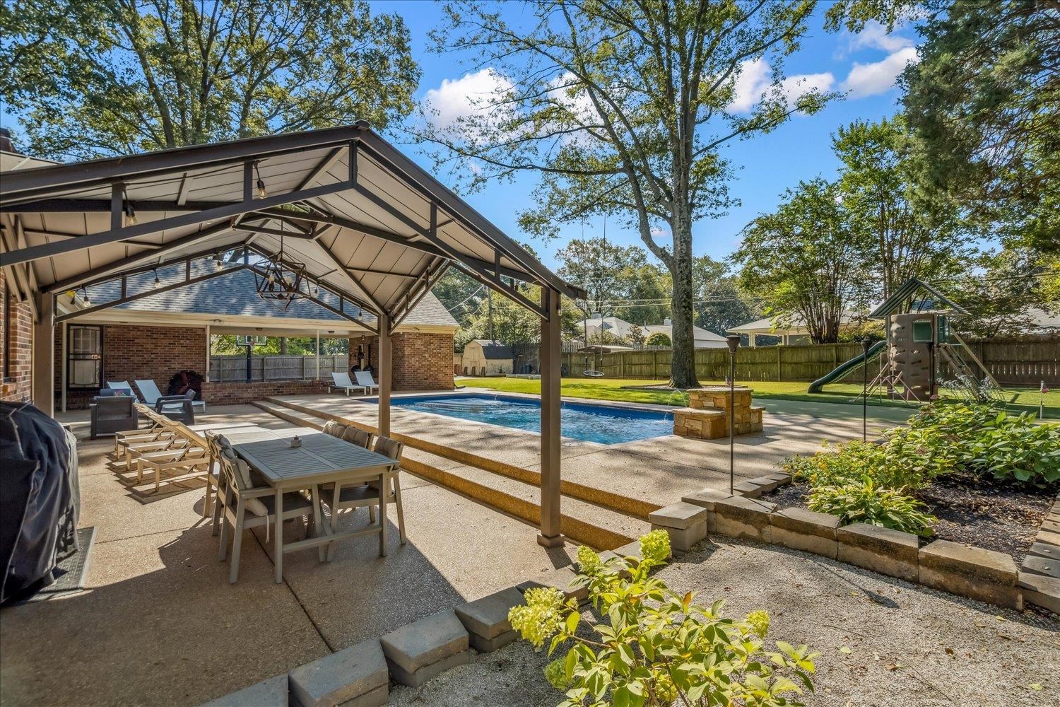 5429 Walnut Grove Road Memphis, TN 38120 - Photo 36 of 37 a view of a chairs and table in the patio