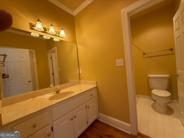 a white toilet sitting next to a bathtub